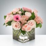Elegant bouquet of pink flowers in a clear glass vase.