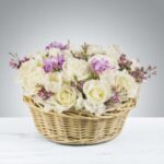 A basket filled with white and pink flowers.