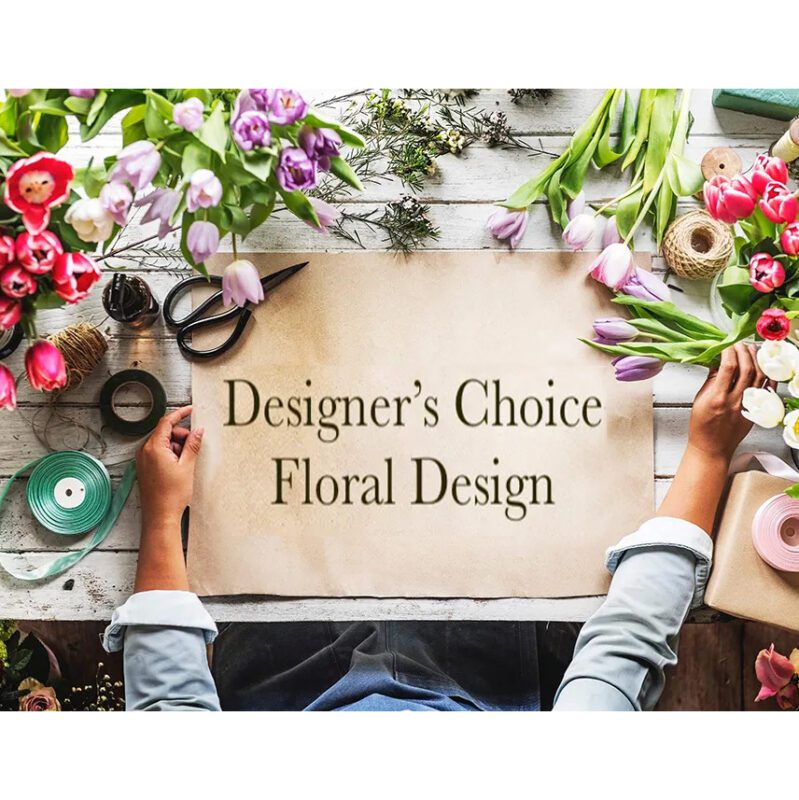 Hands arranging flowers around a blank canvas for floral design.
