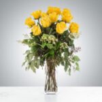 A bouquet of vibrant yellow roses in a clear glass vase.