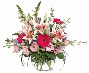 A vibrant bouquet with pink lilies and gerbera daisies in a clear glass vase.