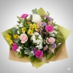 A colorful mixed flower bouquet arranged in a brown box.