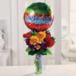 Colorful bouquet with a congratulatory balloon in a bright room.