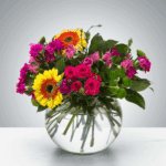 Bright mixed flower bouquet in a clear round vase.