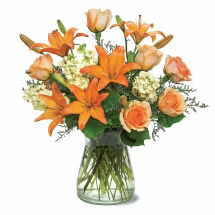 A vibrant bouquet of orange lilies and roses in a clear glass vase.