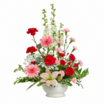A vibrant bouquet of red carnations, pink gerbera daisies, and white lilies with greenery.