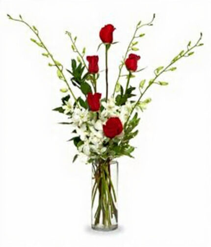 Elegant bouquet with red roses and white flowers in a glass vase.