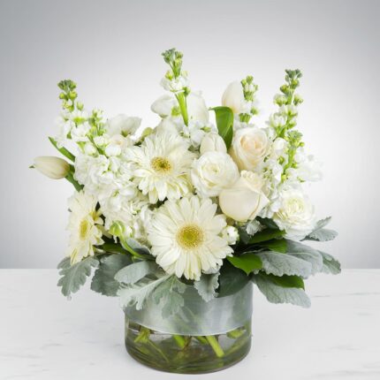 Elegant white floral arrangement in a clear glass vase.