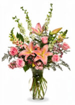 A vibrant bouquet featuring pink lilies and roses with lush greenery.