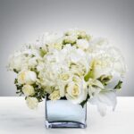 Elegant white floral arrangement in a glass vase.