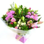 A colorful bouquet of mixed flowers wrapped in clear paper.