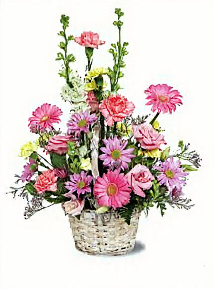 Pink floral arrangement in a white wicker basket.