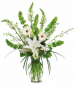 Elegant bouquet of white flowers with greenery in a glass vase.