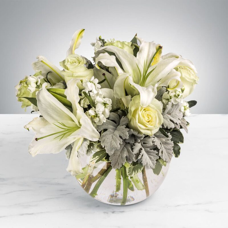 Elegant white floral arrangement in a clear glass vase.