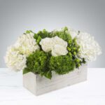 Elegant white and green flower arrangement in a rectangular wooden box.