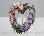Heart-shaped floral wreath with pink and purple roses.