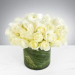Elegant bouquet of white roses in a green vase.