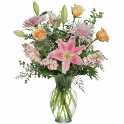 A vibrant bouquet of mixed flowers in a clear glass vase.