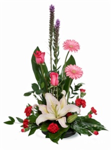 Elegant floral arrangement with pink roses, lilies, and carnations.