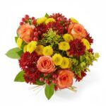 A vibrant bouquet of mixed flowers in a clear glass jar tied with twine.