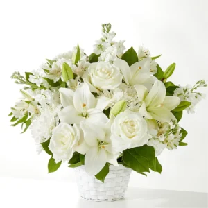 Elegant bouquet of white flowers in a clear vase.