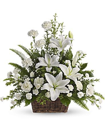 Elegant white floral arrangement in a woven basket.