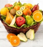 A premium wicker fruit gift basket filled with a variety of fresh orchard fruits including apples, pears, oranges, and sliced kiwis, adorned with a "Congratulations" ribbon.