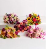 A collection of five diverse floral bouquets with vibrant colors including sunflowers, roses, lilies, and carnations, arranged on a clean white surface.