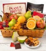A deluxe woven gift basket filled with a variety of fresh fruits including pears, apples, and oranges, along with packaged gourmet treats like peanut brittle, smoked salmon, Ghirardelli chocolates, and dried apricots.
